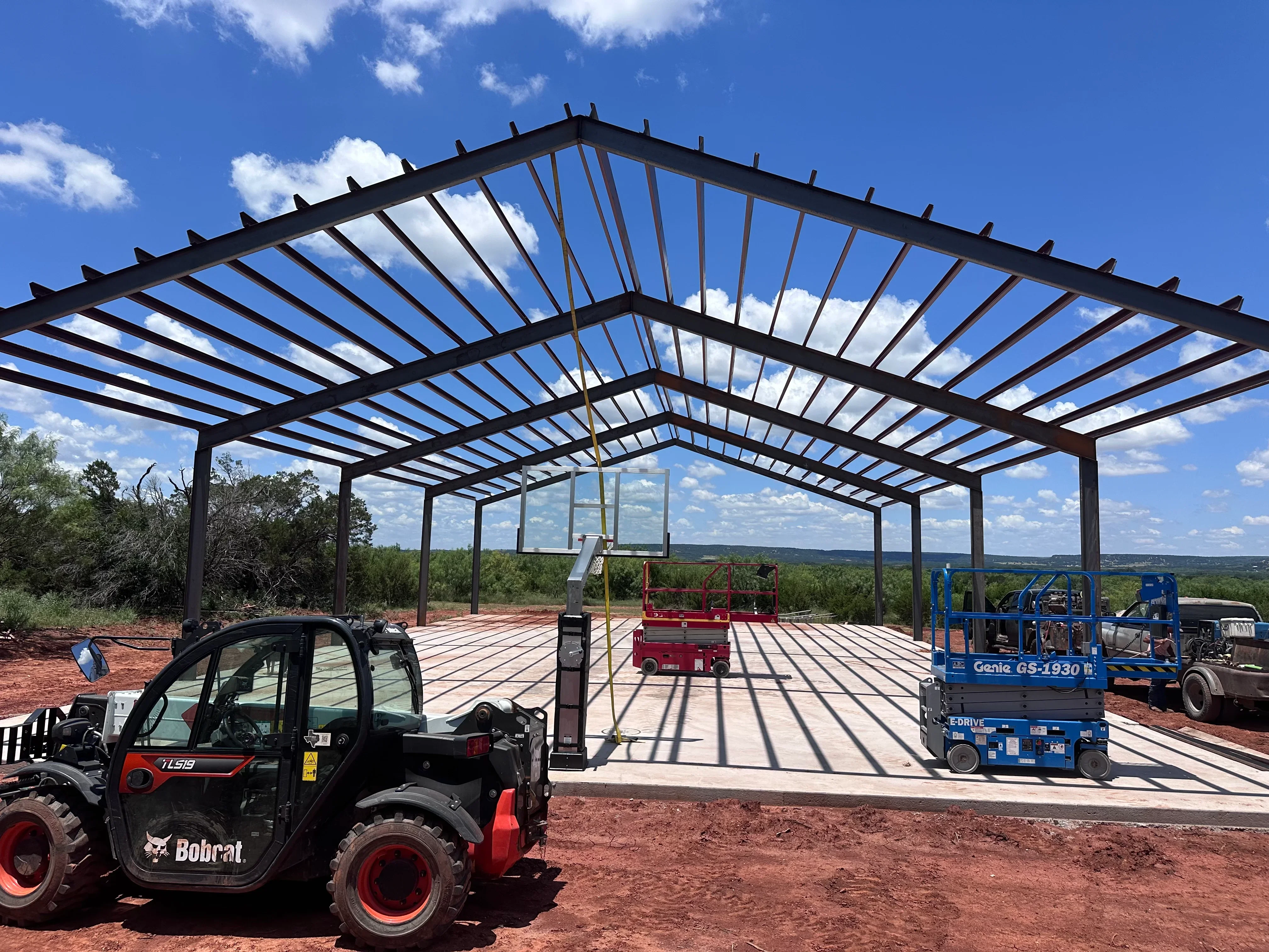 Steel frame pavilion with polycarbonate roof panels and composite decking platform under construction