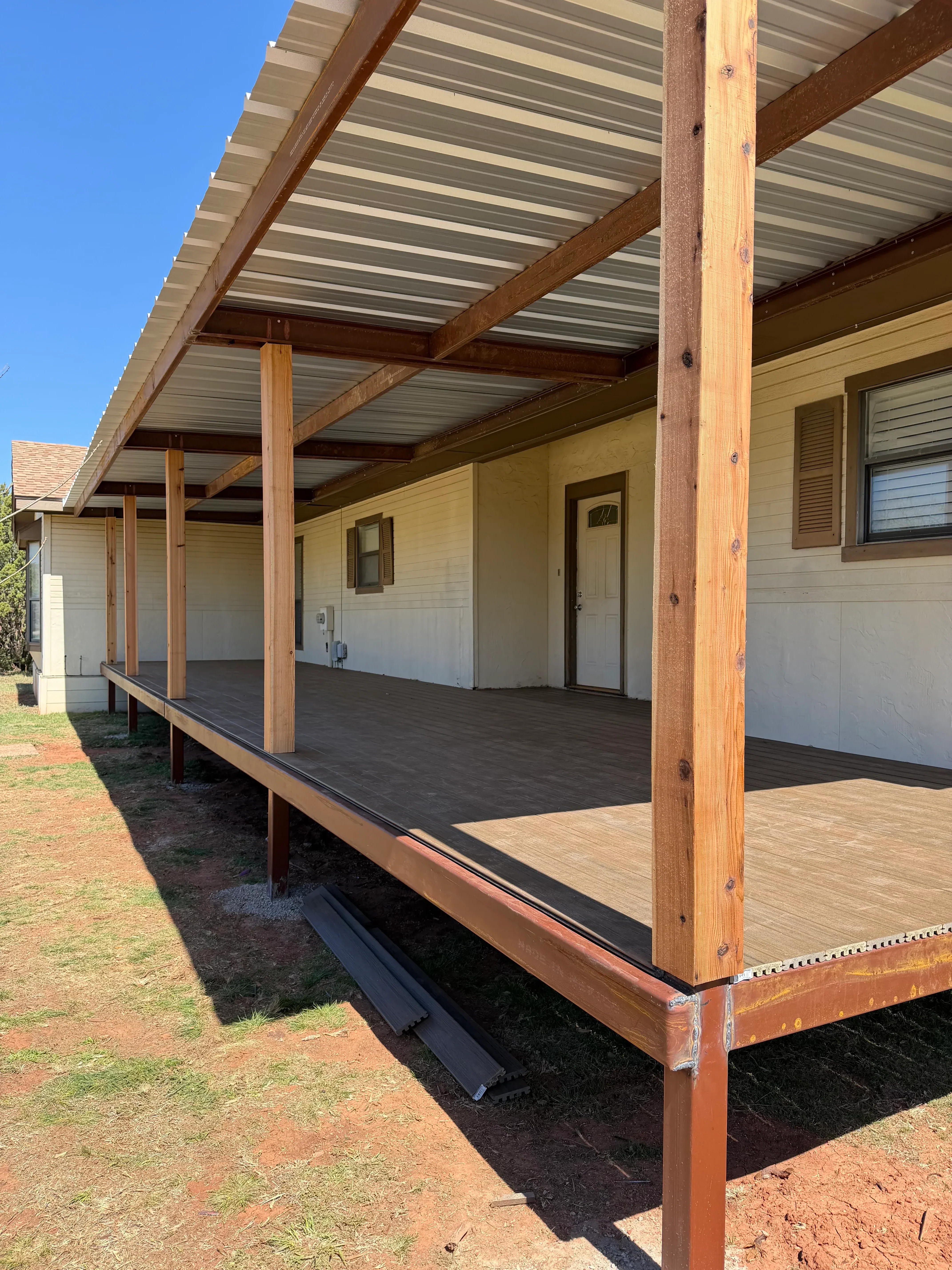 Timber pergola with stained wood beams and metal connectors over patio